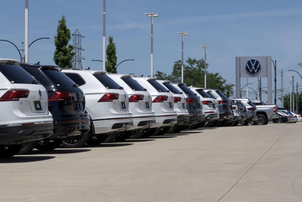 Fila de vehículos Volkswagen en concesionaria de Puebla durante negociaciones con el sindicato Volkswagen por aumento salarial.