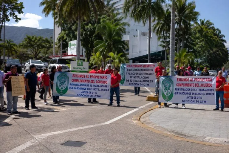 Ex trabajadores participan en una protesta por reinstalación laboral frente a un hotel en Acapulco.